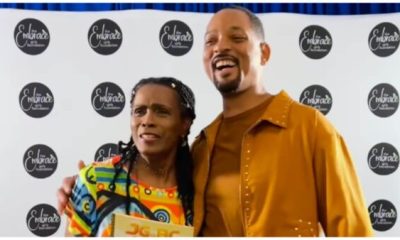 Janet Hubert hugs Will Smith after he shows up to support her at her book signing.