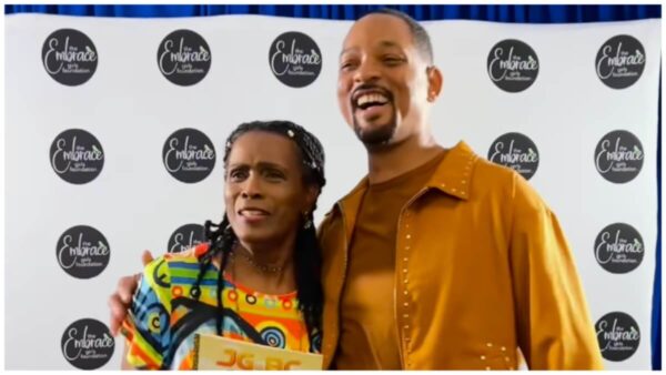 Janet Hubert hugs Will Smith after he shows up to support her at her book signing.