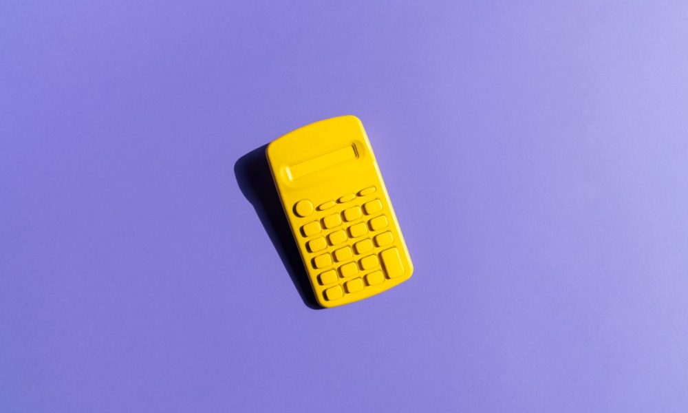 Yellow Calculator On Purple Background; financial model to forecast fundraising