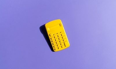 Yellow Calculator On Purple Background; financial model to forecast fundraising