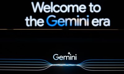 In this photo illustration a Gemini logo and a welcome message on Gemini website are displayed on two screens.