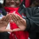 WASHINGTON DC: MARCH 03 The symbol of Delta Sigma Theta Sorority, Inc is displayed for the camera in Washington, D.C. on March 03, 2013. Deltas gathered on the West Front of the United States Capitol and then marched past the White House and finally ended their march on the grounds of the Washington Monument. Members of Delta Sigma Theta Sorority, Inc., the single largest predominantly African-American women