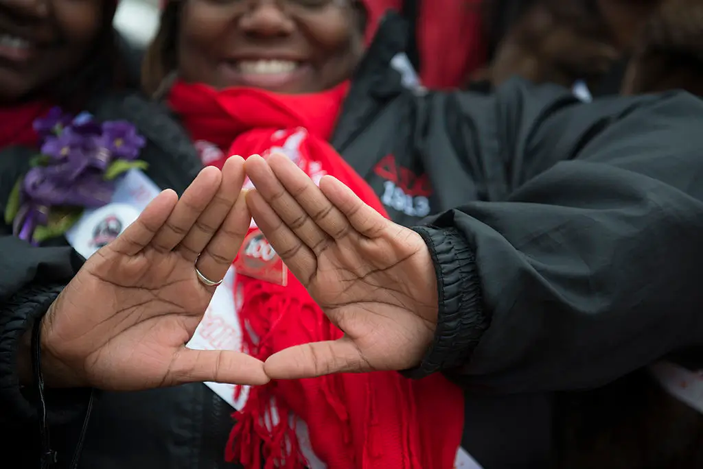 WASHINGTON DC: MARCH 03 The symbol of Delta Sigma Theta Sorority, Inc is displayed for the camera in Washington, D.C. on March 03, 2013. Deltas gathered on the West Front of the United States Capitol and then marched past the White House and finally ended their march on the grounds of the Washington Monument. Members of Delta Sigma Theta Sorority, Inc., the single largest predominantly African-American women