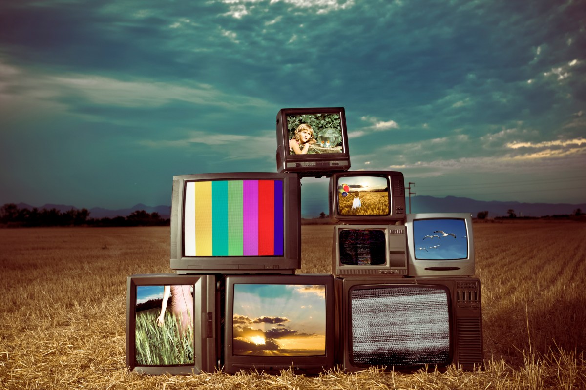 An image of old retro televisions outside with different TV monitors