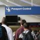 International travelers wait to have their passports checked at O