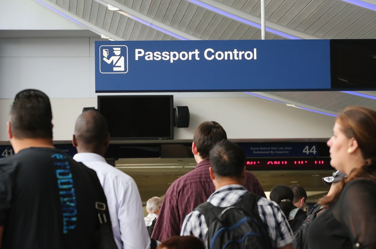 International travelers wait to have their passports checked at O