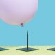 Image of a pink balloon hovering over three spikes to represent risk.