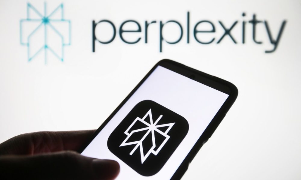 Perplexity AI logo is seen on a smartphone and on a PC screen.