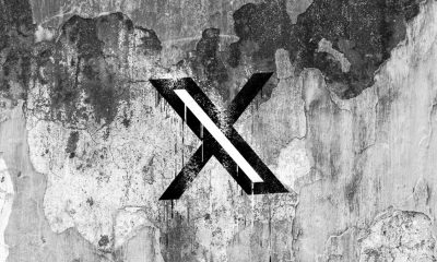 X (formerly Twitter) logo on a cracked wall