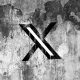 X (formerly Twitter) logo on a cracked wall