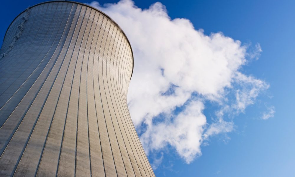 Cooling tower at nuclear power plant emits steam.