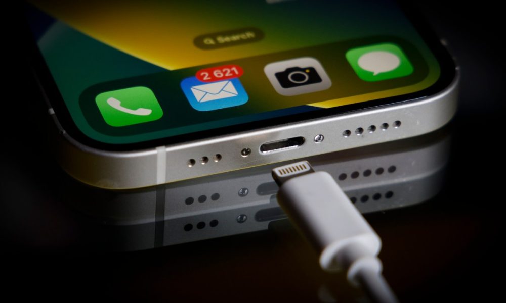 A Apple Lightning port charging cable is seen with with an iPhone in this illustration photo in Warsaw, Poland on 05 October, 2022.